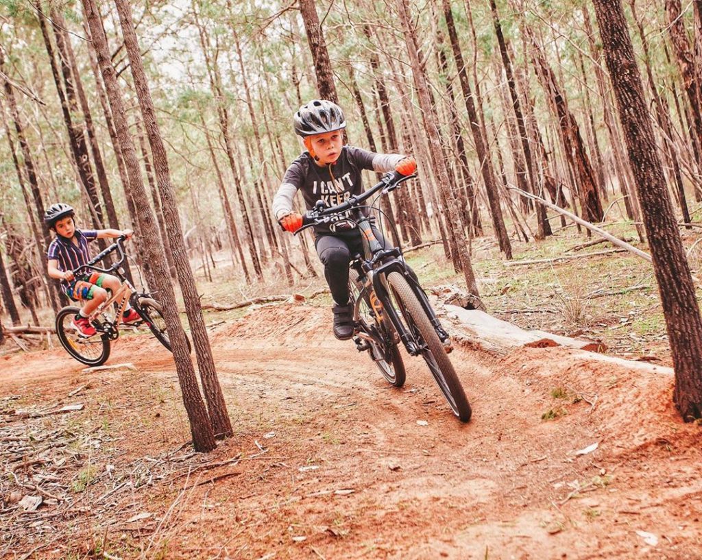 Children mountain biking in the forest in Coolamon