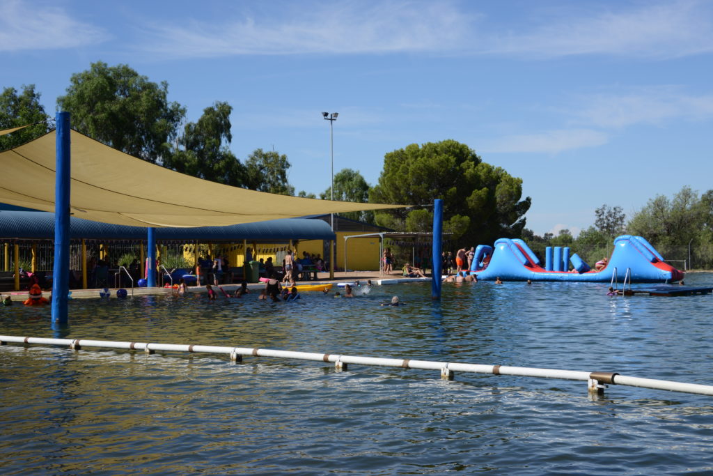 View of Barmedman Mineral Pool showing an inflatable slide and various swimmers enjoying the pool.
