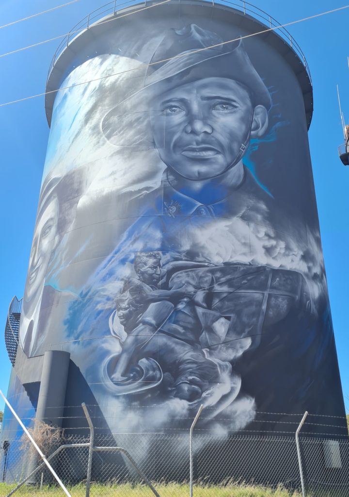 The Image shows a water tower in Hay. On the tower is a painting of Australian soldiers who served during World War II.